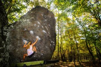 Brianna Knaggs reaching through to the next crimps on "Ranger Rick Sit"(V4)